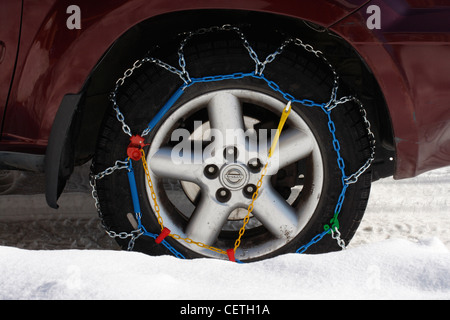 Snow chains on the  wheels of an SUV 4wheel drive vehicle. Stock Photo