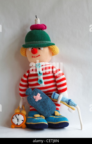 knitted doll, knitted toy - wee willie winkie with candle on head, hot water bottle, alarm clock, toothbrush, toothpaste with paste squirting Stock Photo