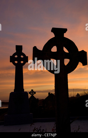 Celtic Cross in graveyard at sunset Stock Photo