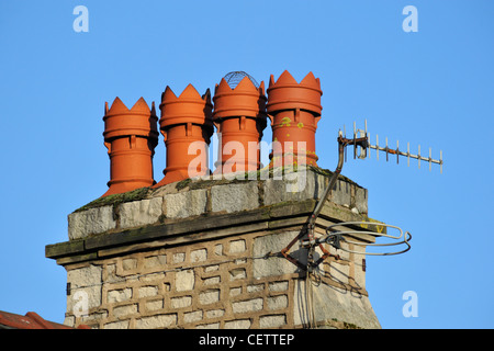 House chimney stack with four pots and two aerials. Romney Road, Kendal, Cumbria, England, United Kingdom, Europe. Stock Photo