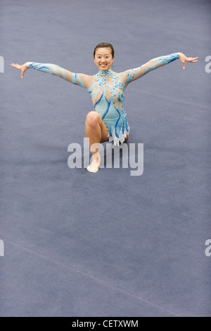 Female gymnast performing floor routine Stock Photo