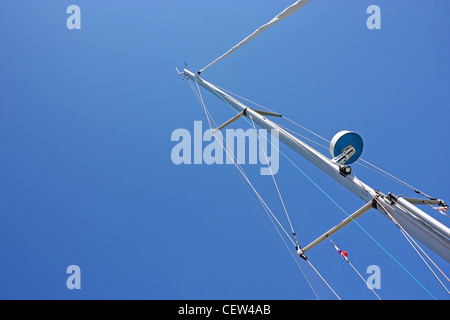 Top of the mast of a sailboat against blue sky Stock Photo