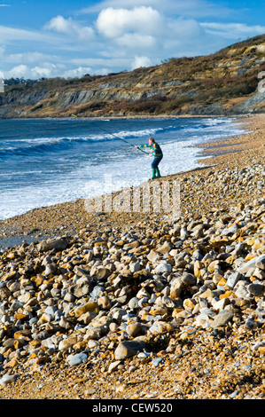 Charmouth beach on the jurassic coast at Charmouth, Dorset, UK taken on sunny day in winter with fisherman on beach Stock Photo