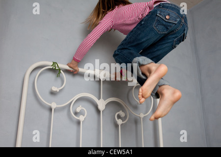 girl jumping on bed Stock Photo