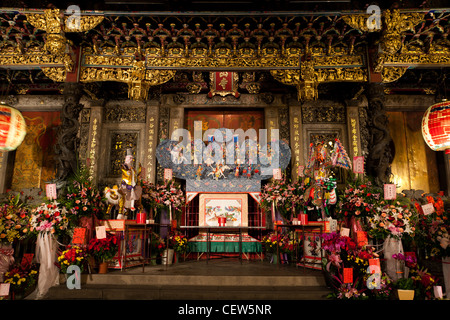 Flower bouquets offerings at Lungshan Temple, historic Buddhist and Taoist temple, seen during its 270th Anniversary, at night, Wanhua, Taipei, Taiwan Stock Photo