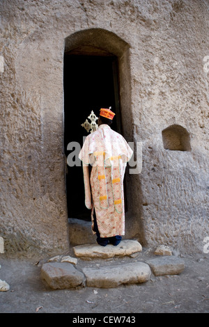 Priest conducting a service at the mountain top monastery of Acheton Mariam looking over Lalibela in Ethiopia Stock Photo