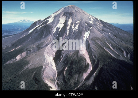 The smallest of five major volcanic peaks in Washington State was Mount St. Helens, with an elevation of 9,677 feet (2,950 meters) before the eruption of May 18, 1980. Another Cascade volcano, Mount Adams (12,286 feet [3,745 meters]), is in the distance. The view is from the west. Stock Photo