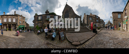 Haworth High Street, West Yorkshire, panoramic view including The Apothocary, The Black Bull pub and the church. Stock Photo