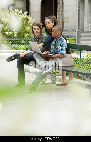 University students studying on campus with laptop computer Stock Photo
