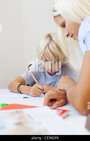 Mother helping son with homework Stock Photo