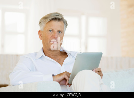 Senior man using digital tablet Stock Photo