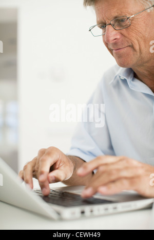 Senior man using laptop computer Stock Photo