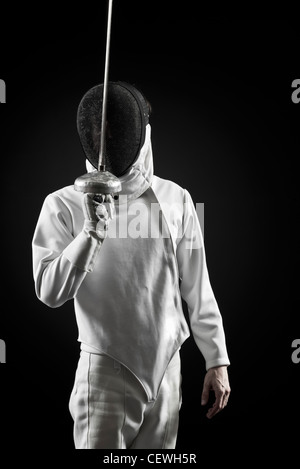 Fencer holding up foil, portrait Stock Photo