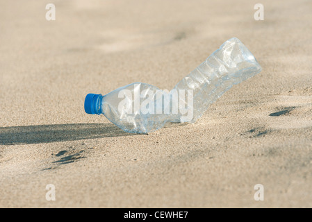 Empty plastic bottle on beach, close-up Stock Photo