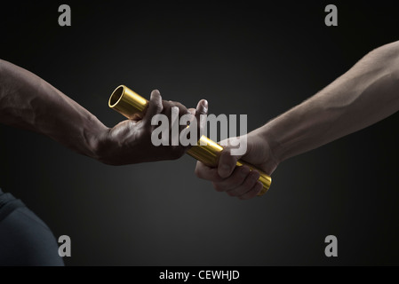 Runners passing baton, cropped Stock Photo