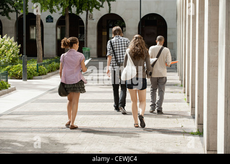 University students walking on campus, rear view