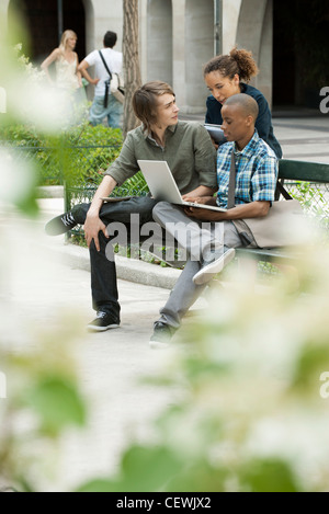 University students studying on campus with laptop computer Stock Photo