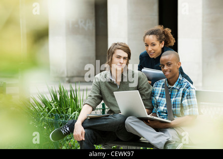 University students on campus with laptop computer Stock Photo