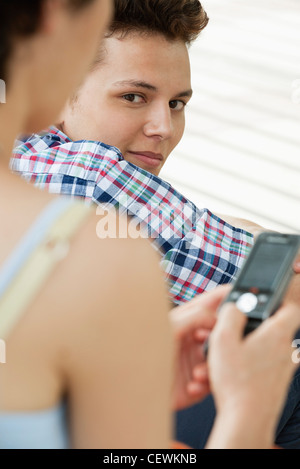 Young man looking over shoulder at camera Stock Photo