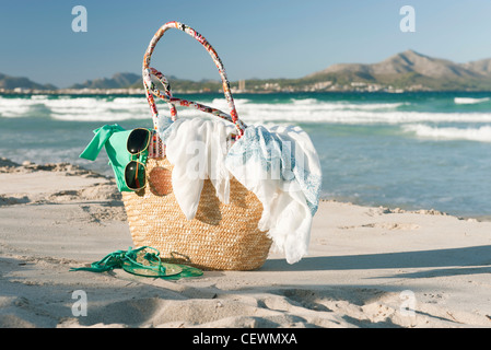 Packed beach bag on beach Stock Photo