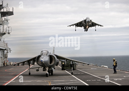 Harrier jet and crew on naval aircraft carrier HMS Illustrius Stock Photo