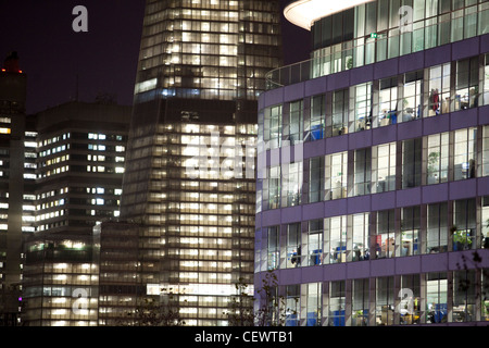 Office lights on in development on South Bank of the Thames in London near Tower Bridge Stock Photo