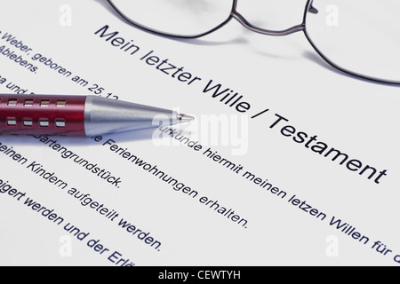 Detail photo of a testament, alongside are a pen and a glasses Stock Photo