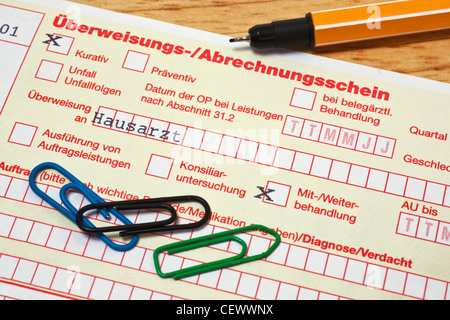 Detail photo of a German letter of referral to general practitioner, a pen and paper clips are alongside Stock Photo