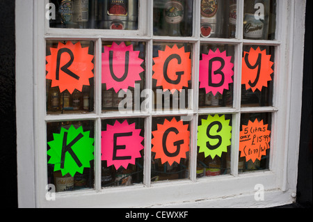 Rugby promotion cheap beer in kegs advert in off licence window Stock Photo