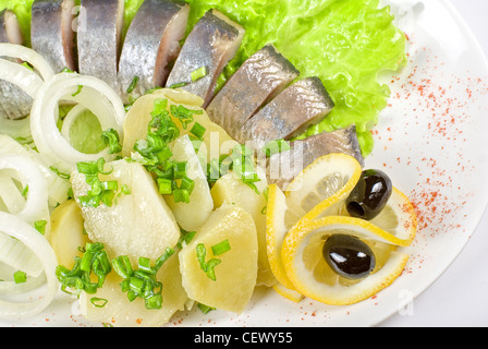 Tasty herring with potato and fresh vegetables Stock Photo