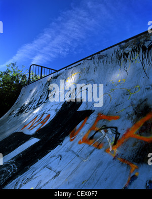 A skateboard ramp covered in graffiti. Stock Photo