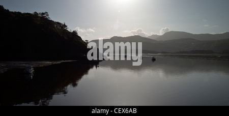 Small boats silhouetted on the Mawddach Estuary. Stock Photo