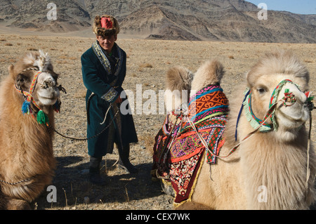 Kazakh man and his Bactrian camel in Western Mongolia Stock Photo