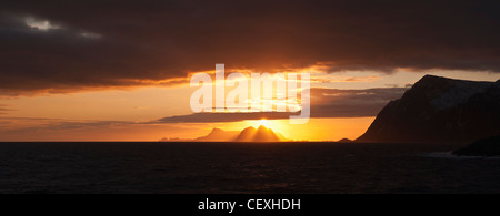 Winter sun sets over Væeroy island viewed from near Å, Lofoten Islands, Norway Stock Photo