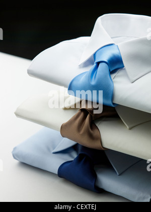 A still life shot of a stack of three mens business shirts and ties Stock Photo