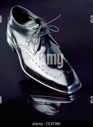 A still life shot of a pair of mens black brogue shoes on a black background Stock Photo