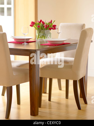 A lifestyle shot of a set dining room table and chars Stock Photo