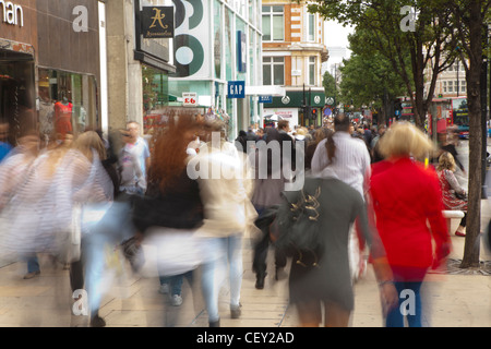 A view down Oxford street, with shoppers moving along the path Stock Photo