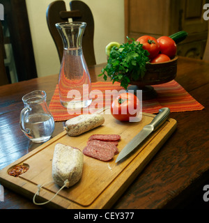 Flat sausage and fresh fruits on a wooden table Stock Photo