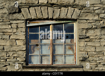 Vandalised window in stone building. Captain French Lane, Kendal, Cumbria, England, United Kingdom, Europe. Stock Photo