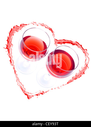 Two glasses of red wine inside red heart drawn with wine on white background Stock Photo