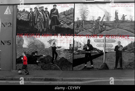 Boy kicking ball past the Shankill Road Mural, Belfast, Northern Ireland, UK, BT13 2AA near Ballysillan Stock Photo