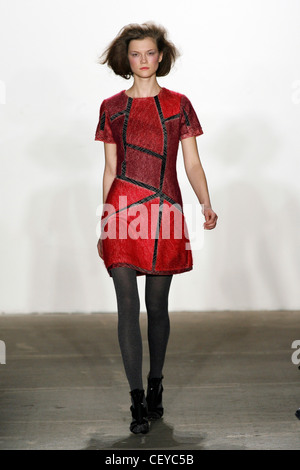 Thakoon New York Ready to Wear Autumn Winter Red and black textured dress with sections, grey tights Stock Photo