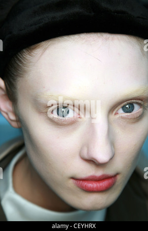 Rick Owens Paris Backstage Ready to Wear Autumn Winter  A female heavy white foundation, whited out eyebrows soft pink cheeks, Stock Photo