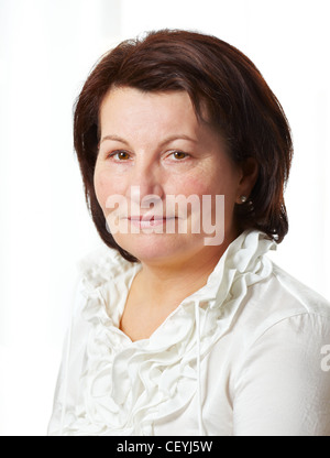 Beautiful middle aged business woman portrait at the office. Stock Photo