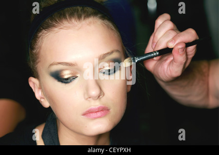 Narciso Rodriguez Backstage New York Ready to Wear Spring Summer Head shot of model having yellow eye makeup applied to brows a Stock Photo