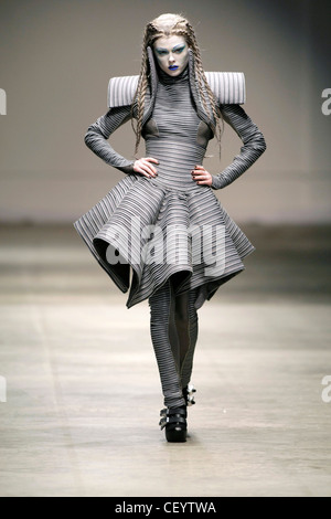 Gareth Pugh London Ready to Wear Autumn Winter Grey striped structured dress with oversize shoulderpads, matching leggings Stock Photo