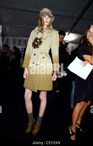 Burberry Prorsum Backstage Milan Ready to Wear Spring Summer Model wearing above the knee length tan two tone deep dyed coat, Stock Photo