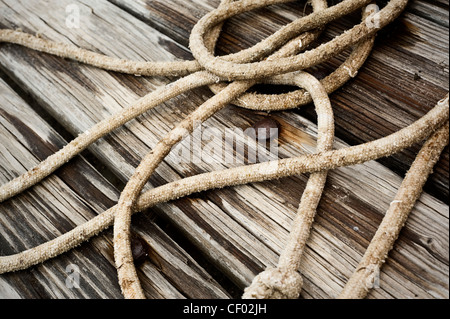 old wooden boards and rusty nails with rope on Stock Photo