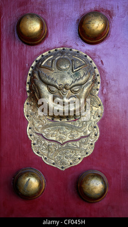 Detail detailed heavy bronze stud studded red door gate entrance decorative gilt knocker Forbidden City Beijing China Stock Photo